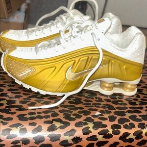 Nike Women’s Shox Sneakers in Gold and White